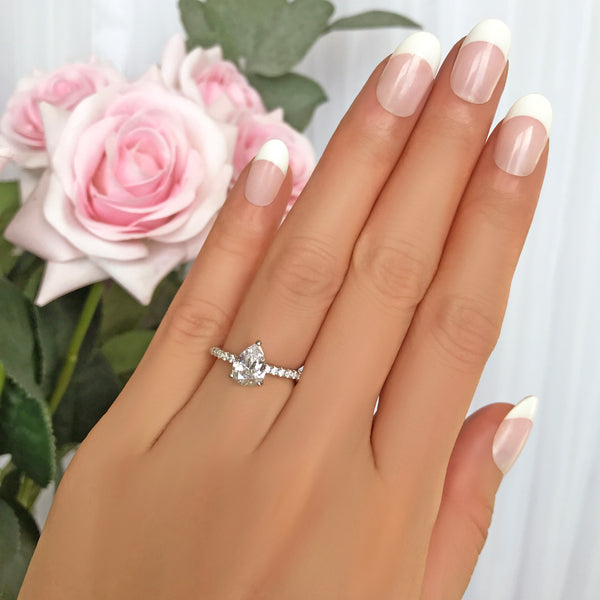 1.5 ctw Pear Accented Solitaire Ring