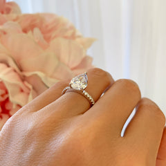 3.25 ctw Pear Accented Solitaire Ring